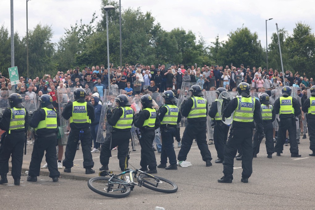 Police officers stand guard during an anti-immigration protest in Britain’s Rotherham in 2024. Photo: Reuters