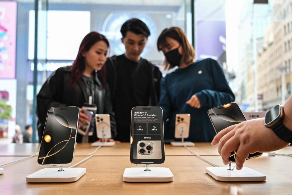 People look at the Iphone 16 at an Apple store in Shanghai on April 11, 2025. US President Donald Trump abruptly paused tariffs on most countries, sparking euphoria on global markets on April 10, but upped the ante on a brutal trade war with superpower rival China. Photo: AFP