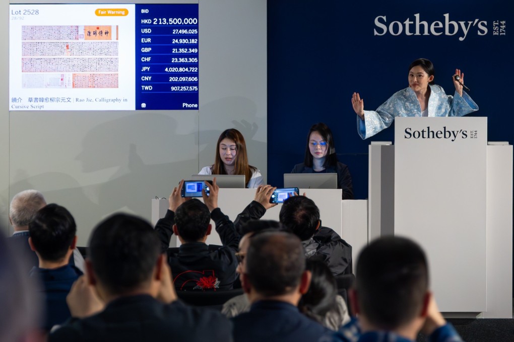 Auctioneer CC Wang presides over the auction of Calligraphy in Cursive Script by Rao Jie at Sotheby’s Hong Kong. The 14th century scroll fetched HK$250.1 million (US$32.1 million) including fees after a bidding war, but market observers don’t see this as a turning point. Photo: Sotheby’s Hong Kong