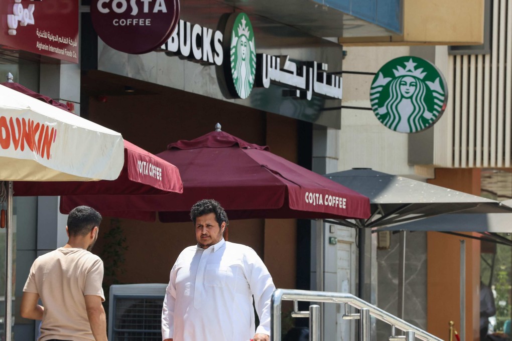 People walk past a Starbucks branch in Riyadh, capital of Saudi Arabia, where a love for all things American endures. Photo AFP