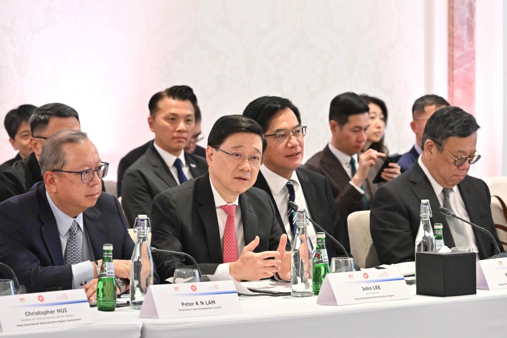 Hong Kong leader John Lee (centre) attends a meeting with Qatari businessmen. Photo: Handout