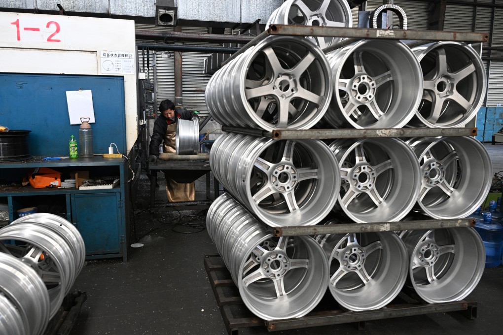A worker puts finishing touches to wheels for exports at a factory in Suqian in Jiangsu province. Photo: Getty Images