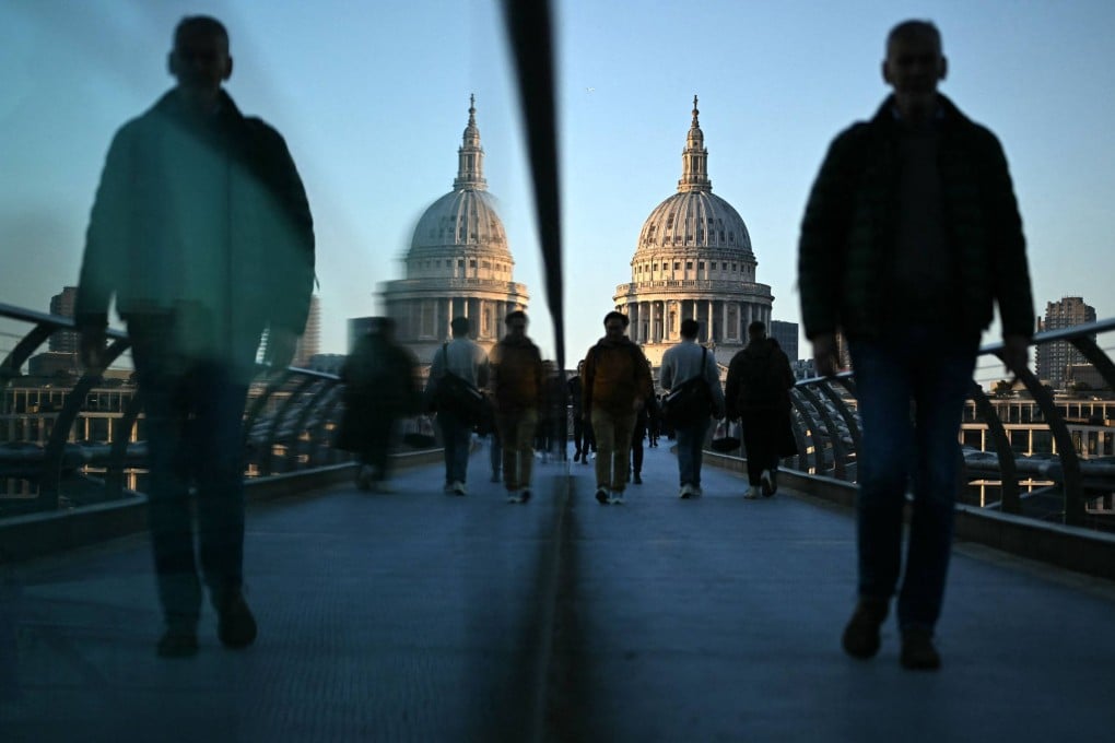 People on the Millennium Bridge in London, with St Paul’s Cathedral in the background. The UK government said on Monday it would be adopting a tougher stance on immigration. Photo: AFP
