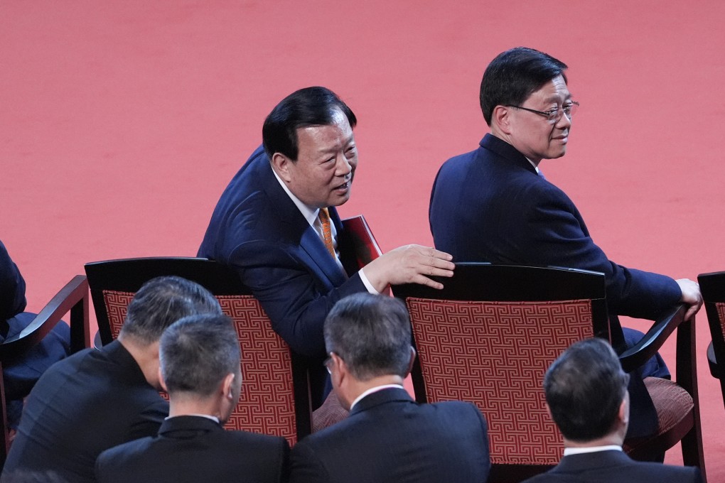 Xia Baolong (left), director of the Hong Kong and Macau Affairs Office, and John Lee. Xia has spelled out his expectations for businesses in a closed-door meeting on Monday. Photo: Eugene Lee