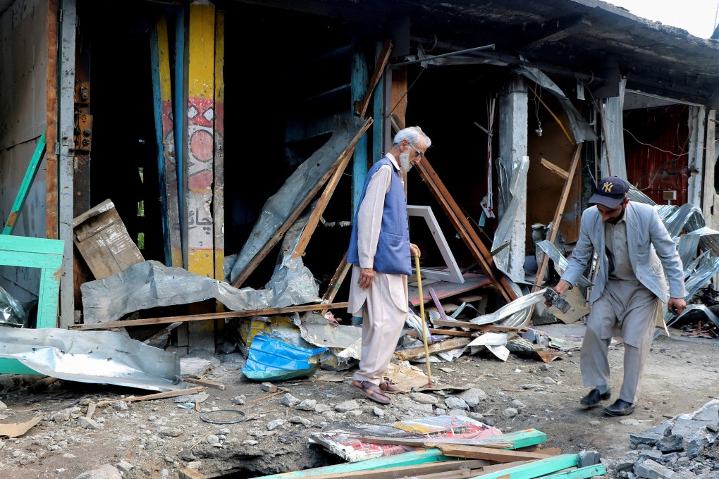 Shopkeepers in Neelum Valley, Pakistani Kashmir, assess the damage on Monday after an Indian air strike. Photo: Reuters