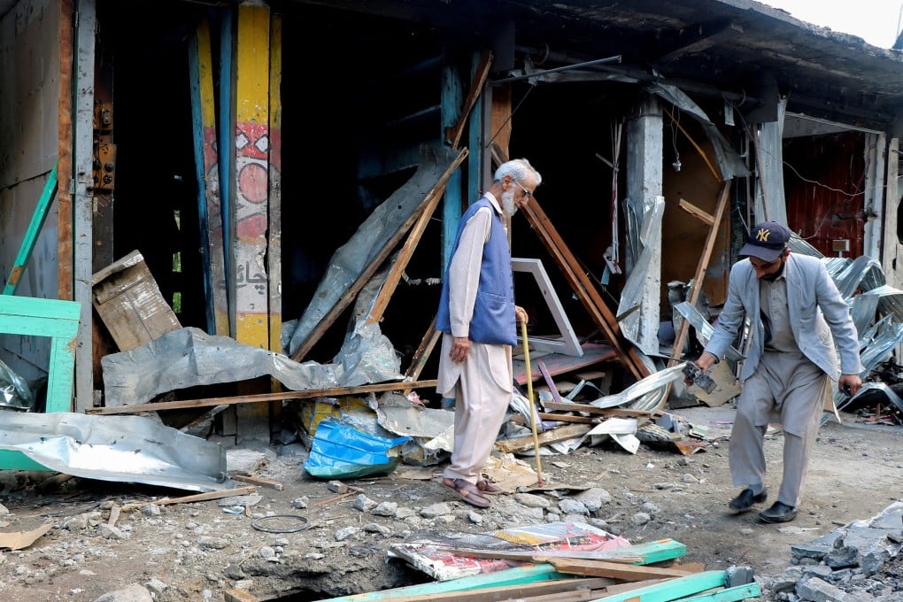 Shopkeepers in Neelum Valley, Pakistani Kashmir, assess the damage on Monday after an Indian air strike. Photo: Reuters