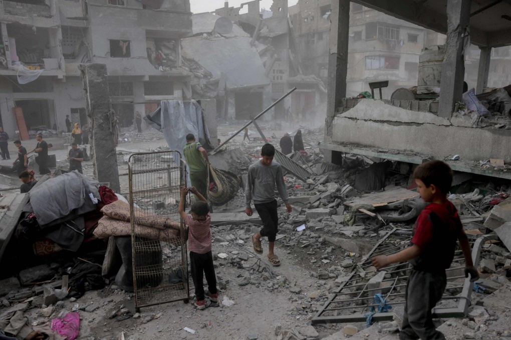 Palestinians salvage items from the rubble of the Fatima Bint Asad school hit in overnight Israeli strikes in Jabalia in the northern Gaza Strip on Monday. Photo: AFP