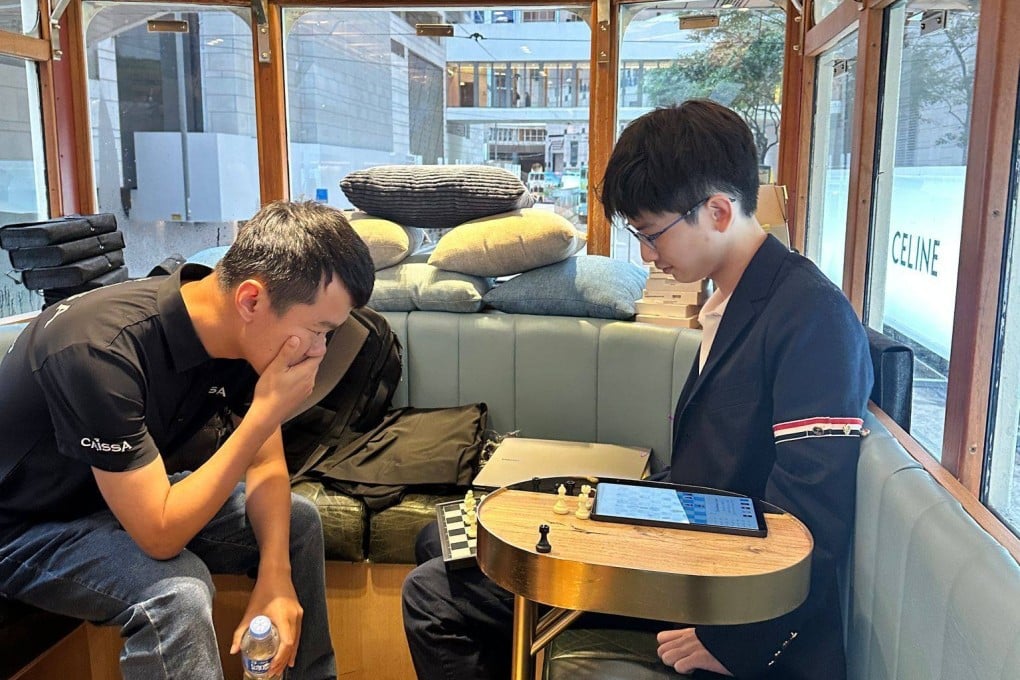 Chinese grandmaster Ding Liren (left) playing against Hong Kong No 1 Jamison Kao and 11 others on a tram. Photo: Hong Kong, China Chess Federation