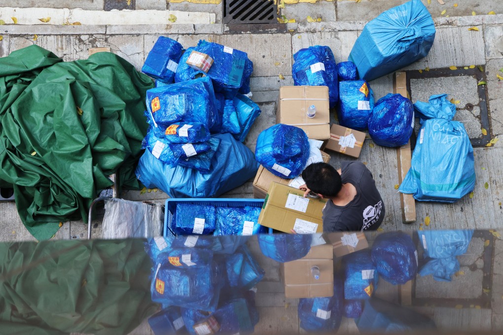 A courier worker handles parcels in Wan Chai. The US has lowered the tariff on small parcels from mainland China and Hong Kong from 120 to 54 per cent. Jelly Tse