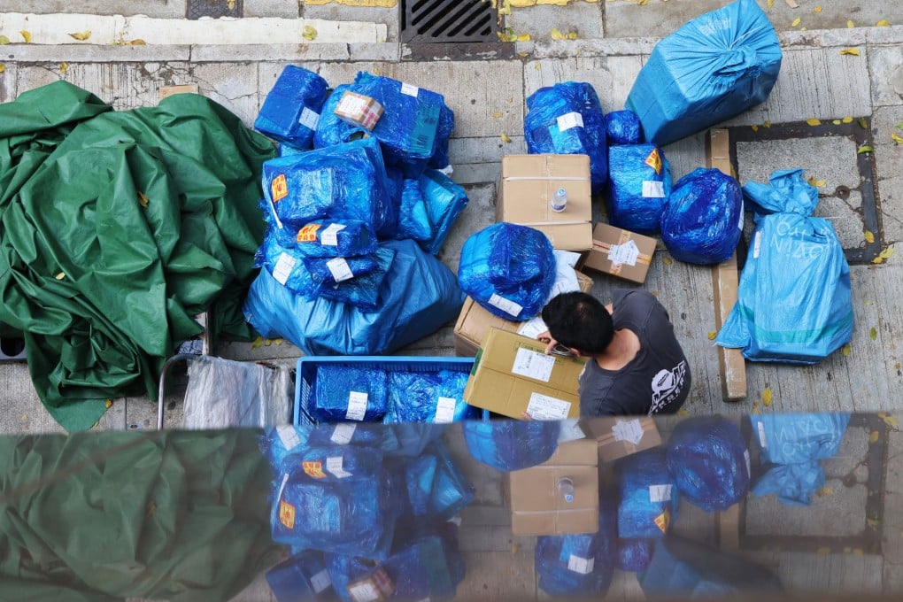 A courier worker handles parcels in Wan Chai. The US has lowered the tariff on small parcels from mainland China and Hong Kong from 120 to 54 per cent. Jelly Tse