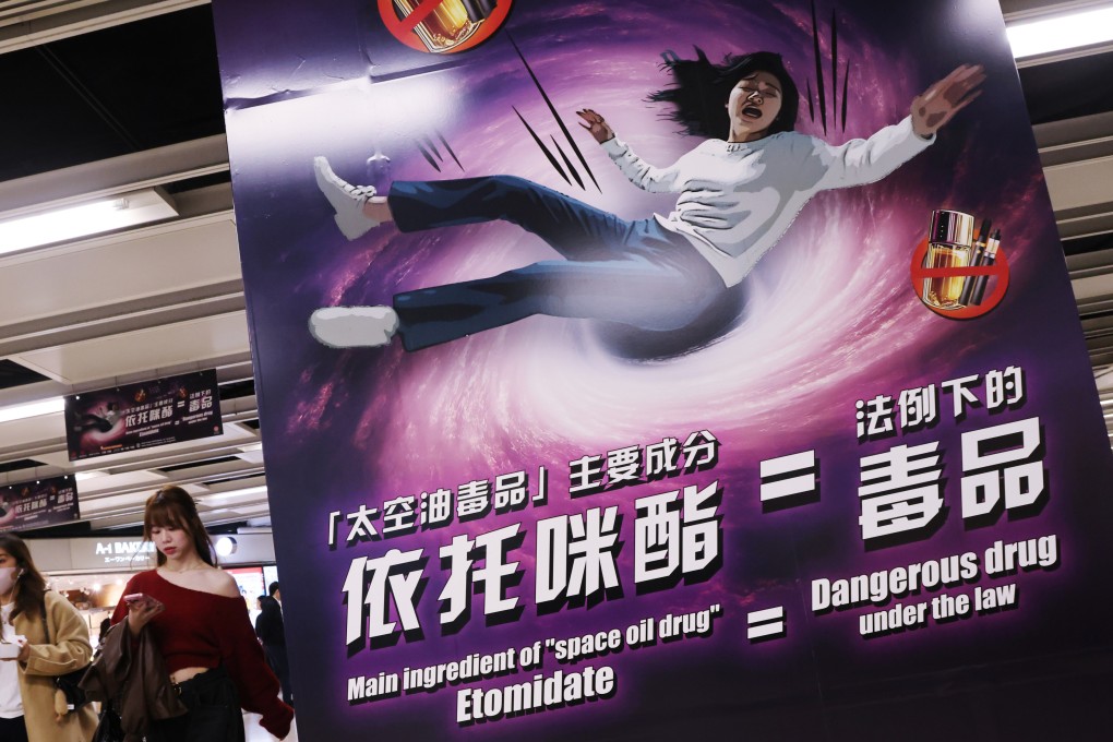 People pass by a poster warning about the dangers of etomidate, or “space oil”, at an MTR station in Hong Kong in February. Photo: Jelly Tse