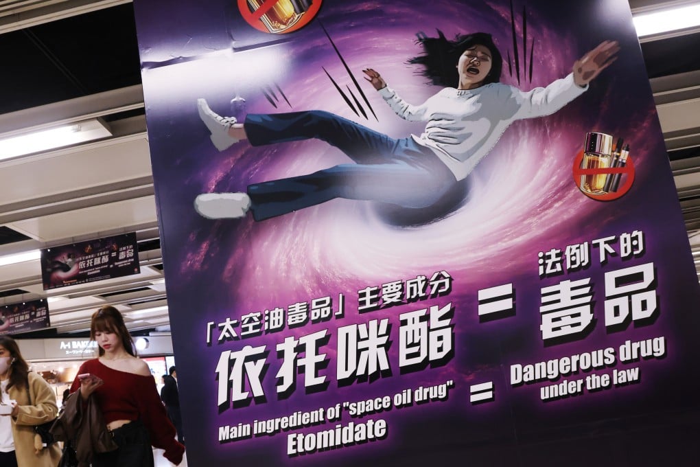 People pass by a poster warning about the dangers of etomidate, or “space oil”, at an MTR station in Hong Kong in February. Photo: Jelly Tse