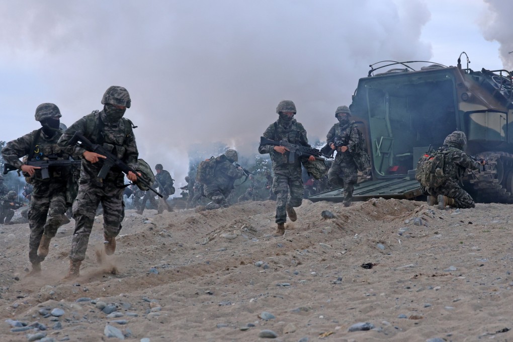 South Korean marines dash out of an assault amphibious vehicle at a beach during a landing drill at a beach in Pohang, North Gyeongsang province, on April 28. Photo: EPA-EFE/Yonhap