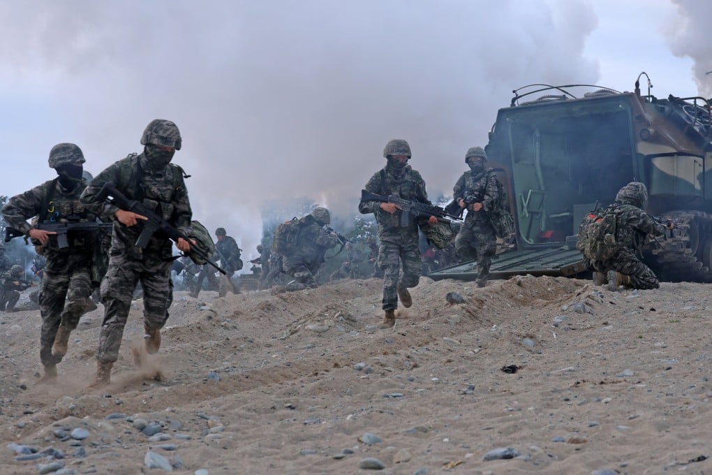 South Korean marines dash out of an assault amphibious vehicle at a beach during a landing drill at a beach in Pohang, North Gyeongsang province, on April 28. Photo: EPA-EFE/Yonhap