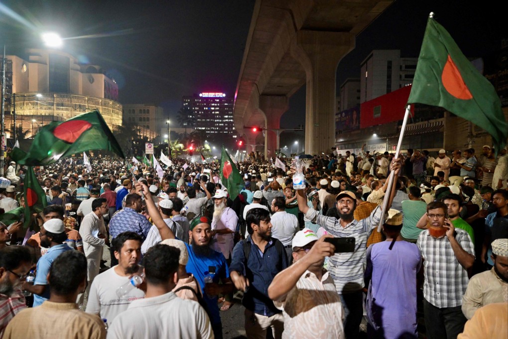 Bangladeshis wave national flags as they celebrate after the interim government officially banned all activities of the Awami League, pending the conclusion of the International Crimes Tribunal trials against the party and its leaders, in Dhaka on May 10. Photo: AFP