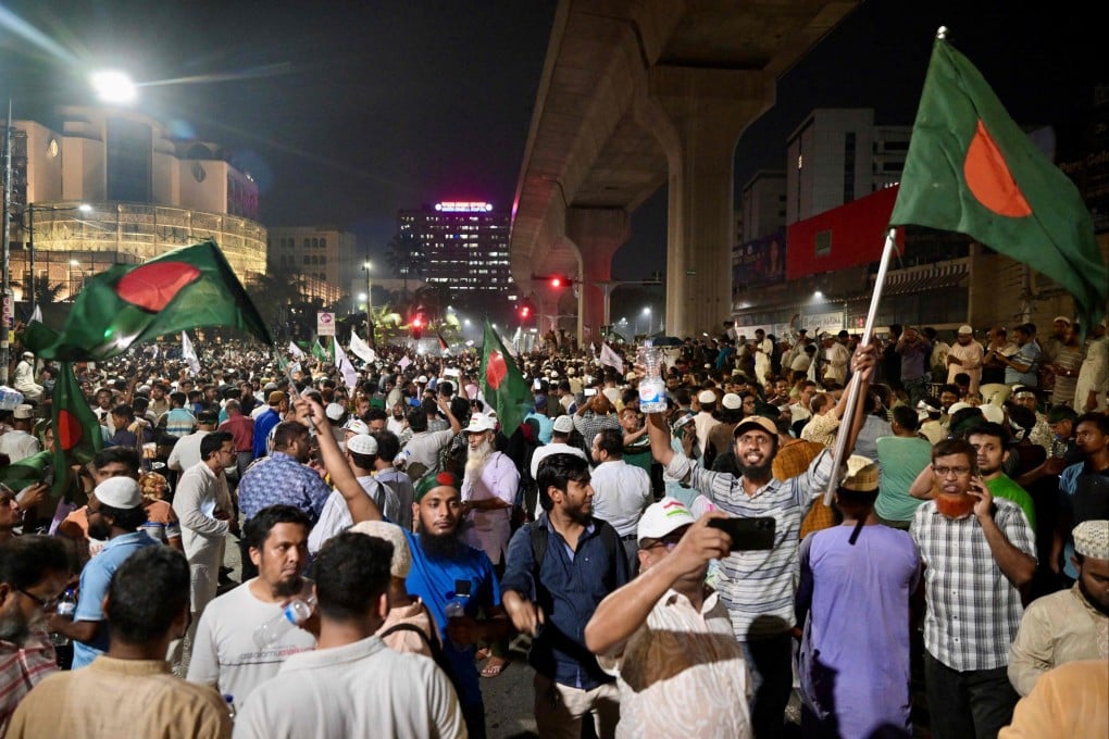 Bangladeshis wave national flags as they celebrate after the interim government officially banned all activities of the Awami League, pending the conclusion of the International Crimes Tribunal trials against the party and its leaders, in Dhaka on May 10. Photo: AFP