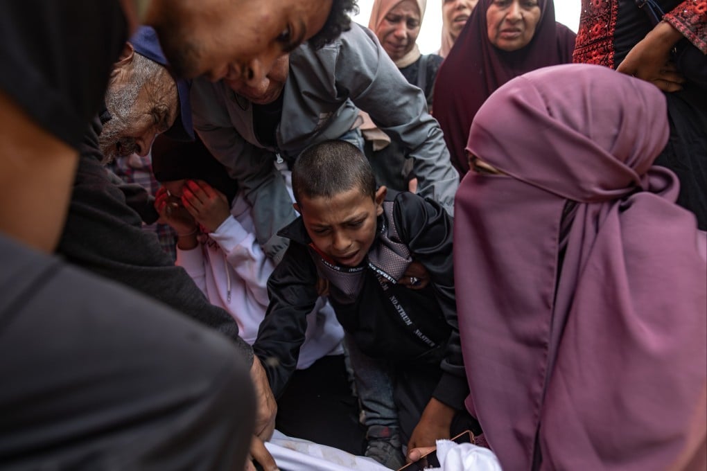 Relatives mourn next to the body of their loved one after an Israeli airstrike on a medical clinic in Gaza on Thursday. Photo: EPA-EFE