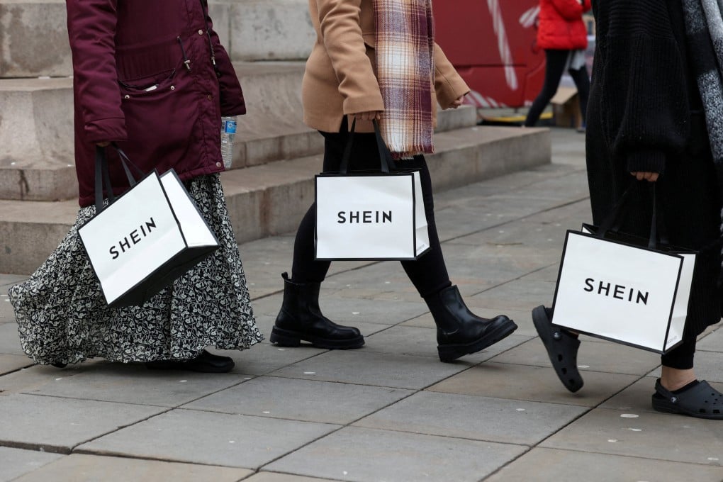 Shoppers carry bags with promotional merchandise as they visit fashion retailer Shein’s Christmas bus tour, in Manchester, Britain, December 13, 2024. Photo: Reuters