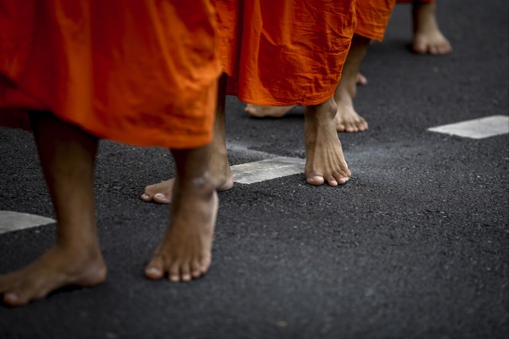 Thai Buddhist monks wait to receive alms at a Bangkok temple in 2022. Photo: EPA-EFE