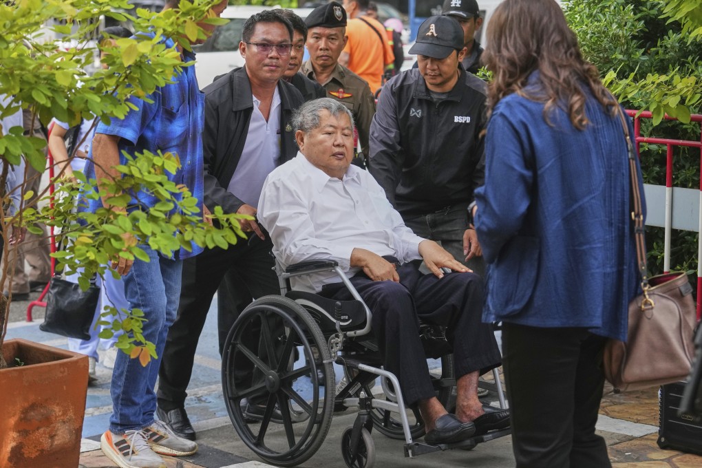 Thai tycoon Premchai Karnasuta arrives at a police station in Bangkok on Friday. Photo: AP