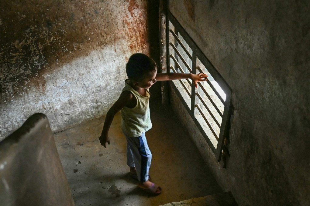 A Rohingya refugee child looks out of a window in a house on the outskirts of Chennai, India. Photo: AFP