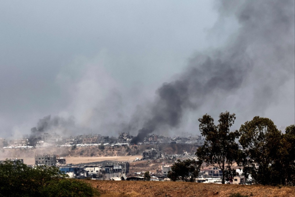 Smoke billows over destroyed buildings on the Gaza Strip during Israeli bombardment on Saturday. Photo: AFP