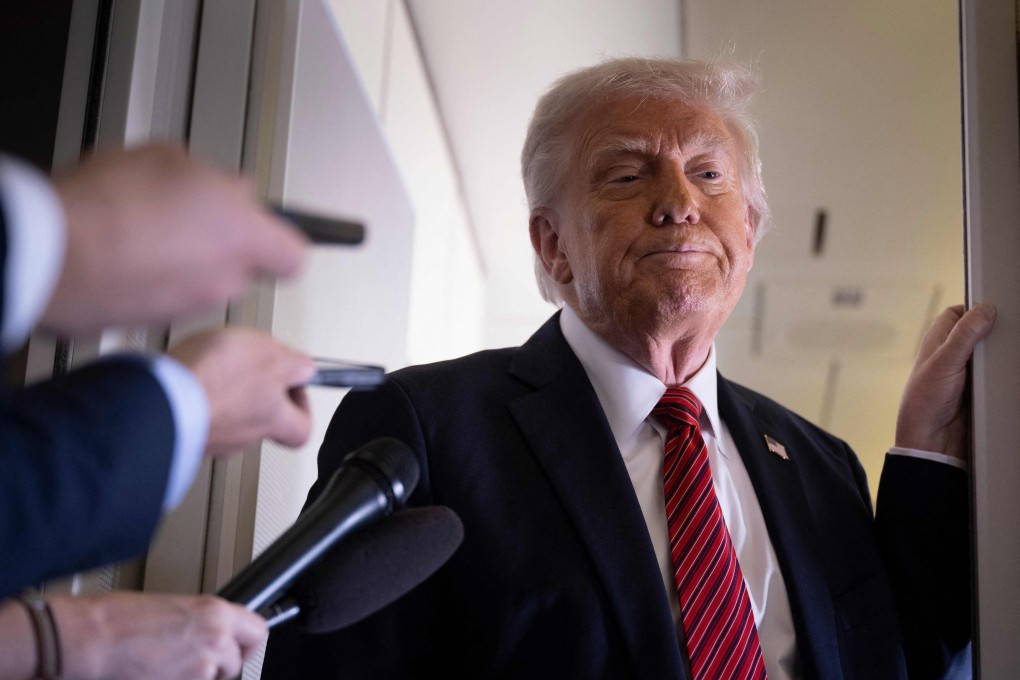 US President Donald Trump listens to questions as he speaks to members of the press on Air Force One on Wednesday. Photo: AFP