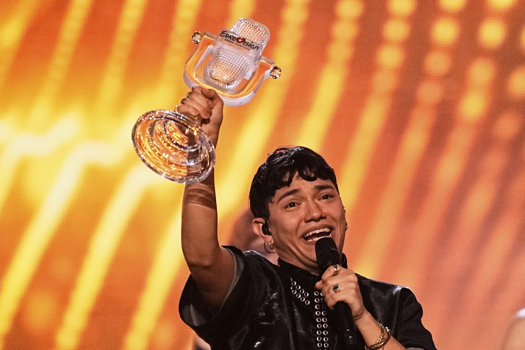 JJ from Austria holds up the Eurovision trophy he won. Photo: AP