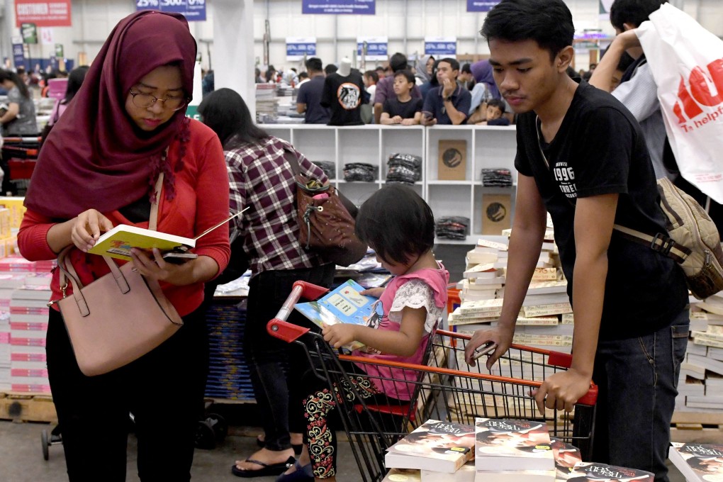 An Indonesian family browsing at a book fair in the suburbs of Jakarta. Indonesia’s younger generations have little or no memory of Suharto’s 1966-1998 New Order era. Photo: AFP