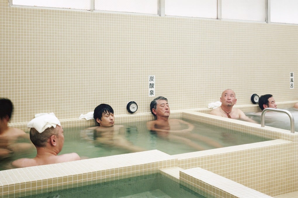 Men bathing in Koganeyu, a sento, or traditional public bathhouse, in Tokyo. Visitors to Japan can go “sento running” – have a run from a bathhouse and return for a bath or shower, and sauna. Some rent out running gear. Photo: Yurika Kono