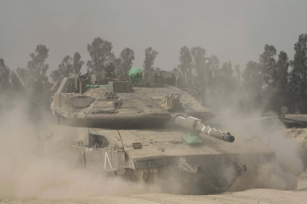 Israeli soldiers move tanks around staging area near the border with the Gaza Strip, in southern Israel, Sunday, May 18, 2025. (AP Photo/Ariel Schalit)