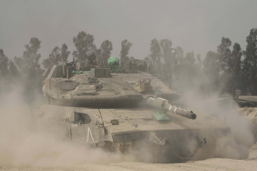Israeli soldiers move tanks around staging area near the border with the Gaza Strip, in southern Israel, Sunday, May 18, 2025. (AP Photo/Ariel Schalit)