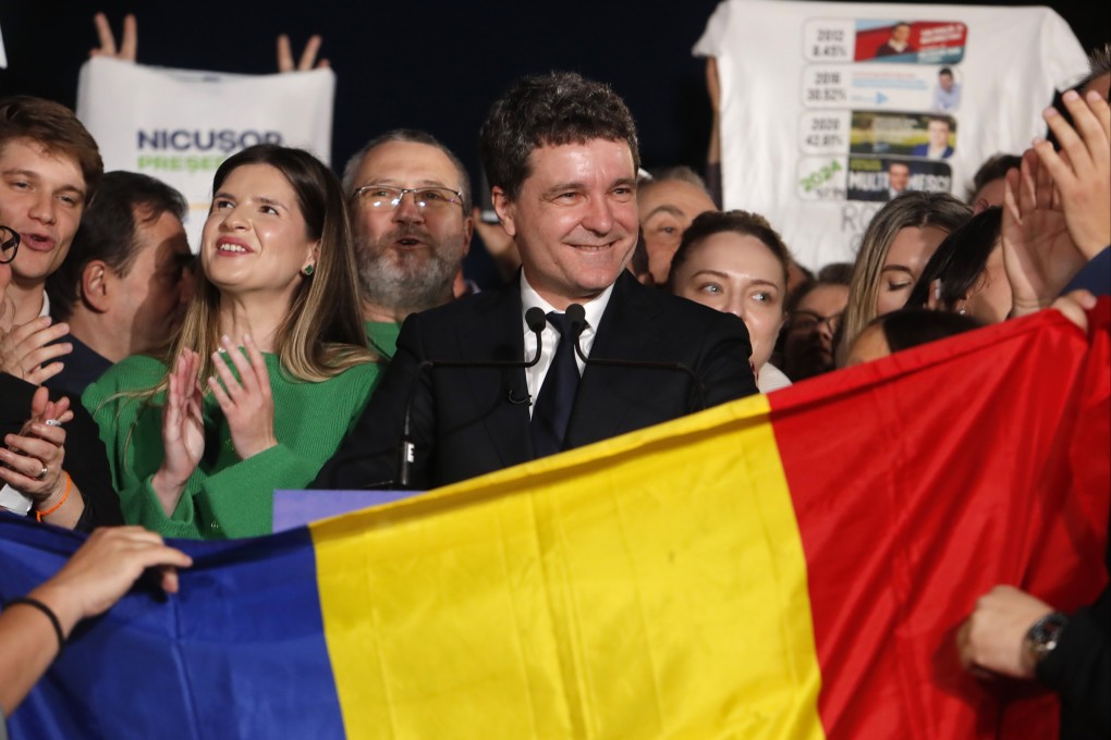 Nicusor Dan, centre, Bucharest mayor and independent presidential candidate supported by the Force of the Right (FD), delivers his speech after the first exit poll results are announced in Cismigiu Park, Bucharest, Romania on Sunday. Photo: EPA-EFE