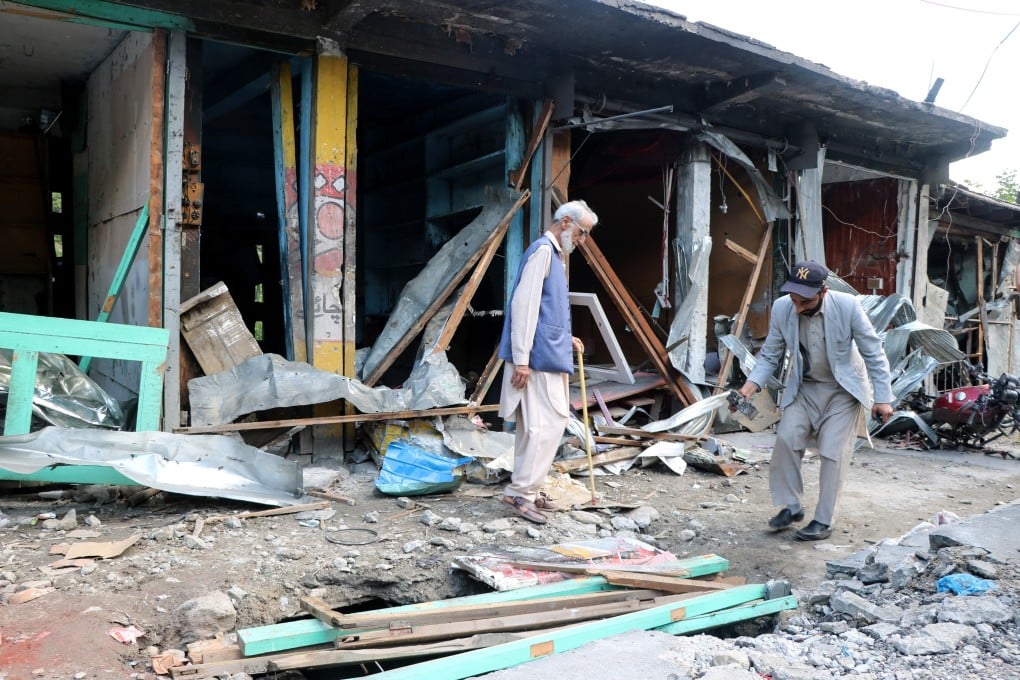 People inspect a market damaged in cross-border shelling before the India-Pakistan ceasefire came into effect, in Jura village, Neelum Valley, in Pakistan-administered Kashmir, on May 12. Photo: EPA-EFE