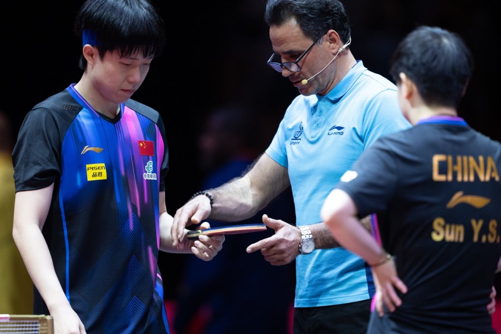 Wang Chuqin (left) has his bat inspected as he and Sun Yingsha prepare to play at the World Table Tennis Championships. Photo: Xinhua
