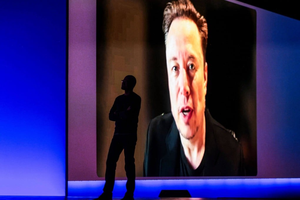 Microsoft CEO Satya Nadella is silhouetted as a pre-recorded interview with Elon Musk is played. Photo: AFP