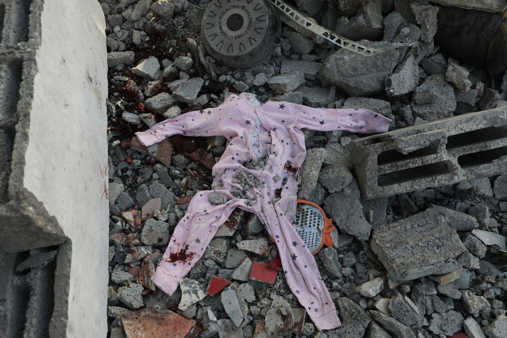 Bloodied children’s clothes are seen among the rubble of a damaged building following overnight Israeli strikes near the Nuseirat Refugee camp. Photo: dpa