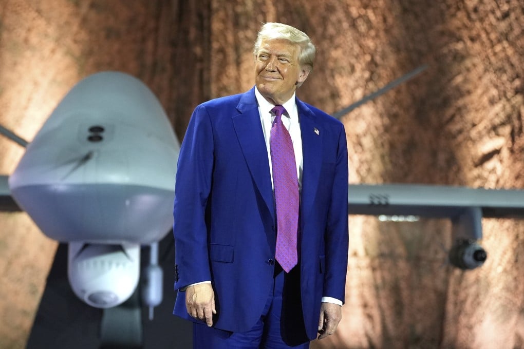 US President Donald Trump stands in front of an MQ-9 Reaper drone before addressing military personnel at Al Udeid Air Base in Qatar on Thursday. Photo: AP