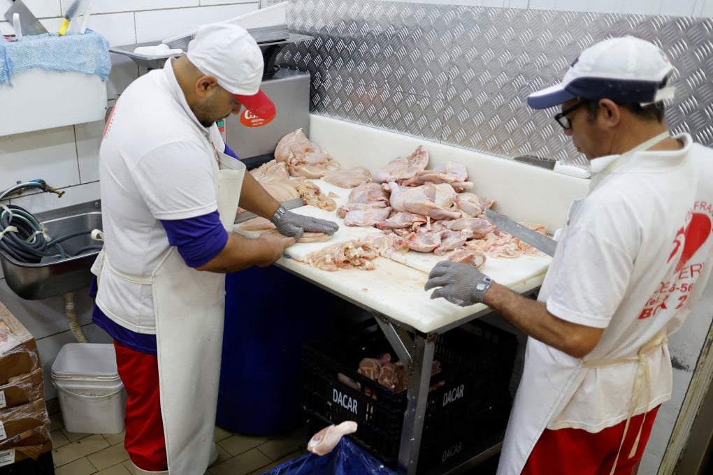 Chicken vendors work in a market in Sao Paulo, Brazil on Tuesday. Photo: Reuters