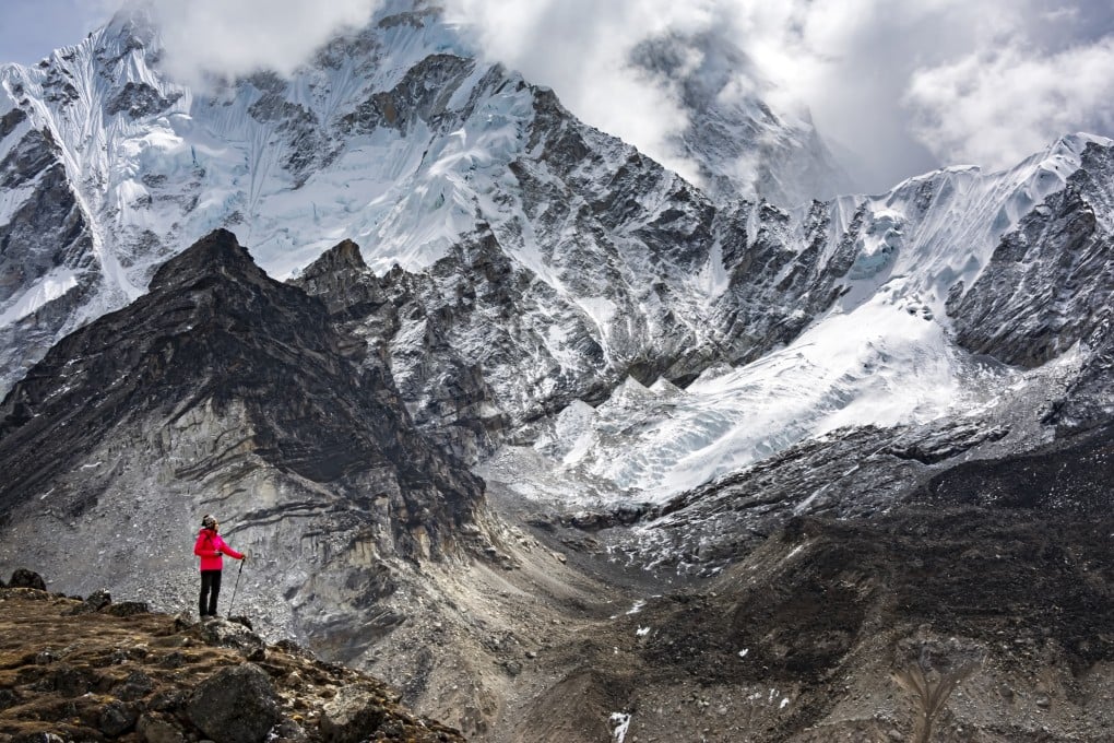 A trekker enjoys the view of the Himalayan mountains during Everest Base Camp trekking in Nepal. Photo: Getty Images