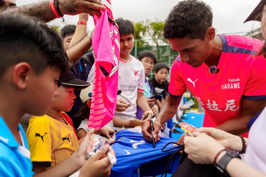 Raphael Varane signs merchandise for fans at the Soccer Sevens in Hong Kong on Sunday. Photo: HKFC Standard Chartered Soccer Sevens