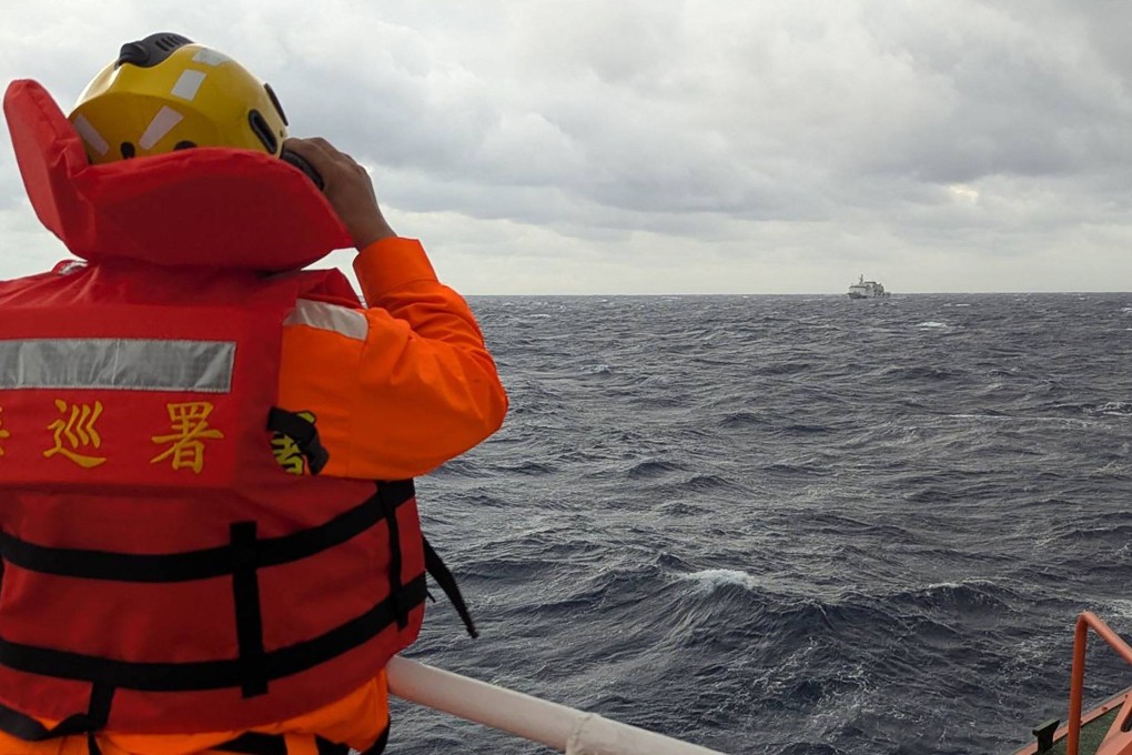 A crew member aboard a Taiwanese coastguard ship monitors a mainland Chinese vessel in waters east of Taiwan in December of last year. Photo: AFP/Taiwanese coastguard