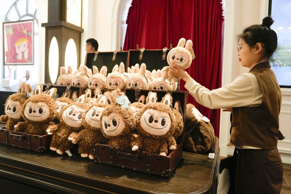 A worker stocks Labubu dolls at Pop Land, a theme park for Pop Mart in Beijing, on May 1, 2025. Photo: AP