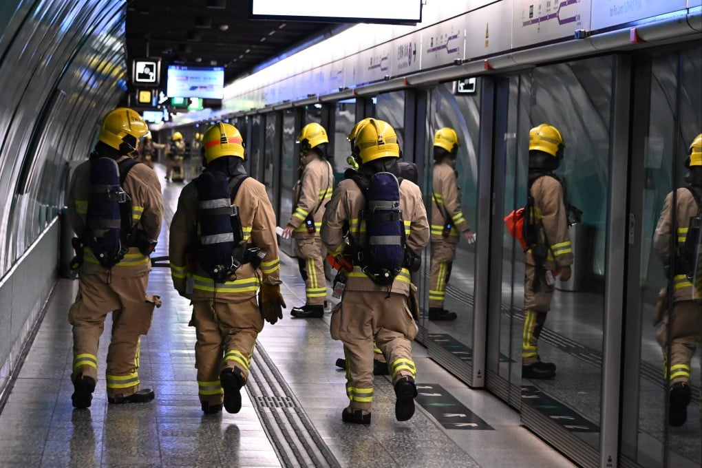Firefighters inspect a platform in Quarry Bay station. Photo: Handout