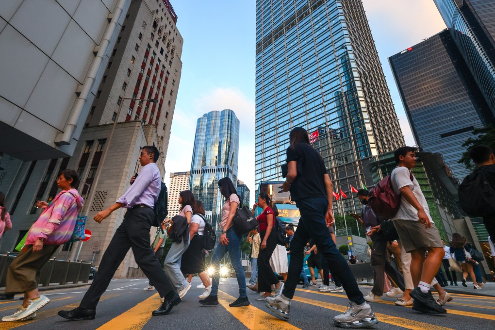 Commuters cross Queen’s Road Central in Hong Kong’s Central district in October last year. AI advancements present opportunities for increased efficiency, but also risks of job displacement, and there is a need to upskill workers so they can keep up. Photo: Dickson Lee