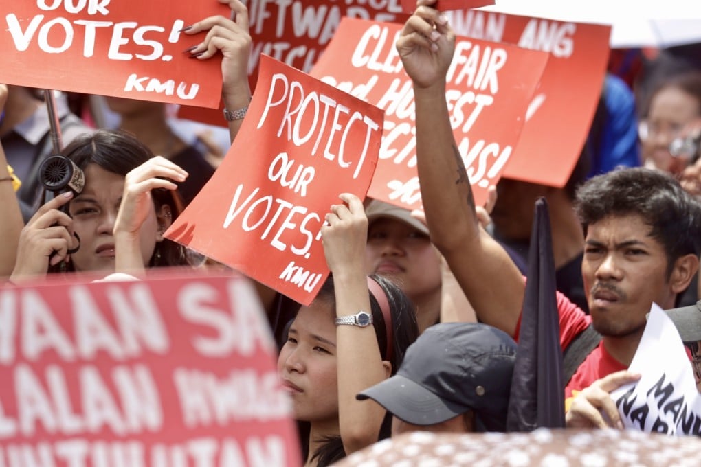 Protesters gestures and hold placards during a demonstration against electoral fraud on the first day of canvassing of votes outside the Commission on Elections (Comelec) office in Manila, Philippines, on May 13. Photo: EPA-EFE