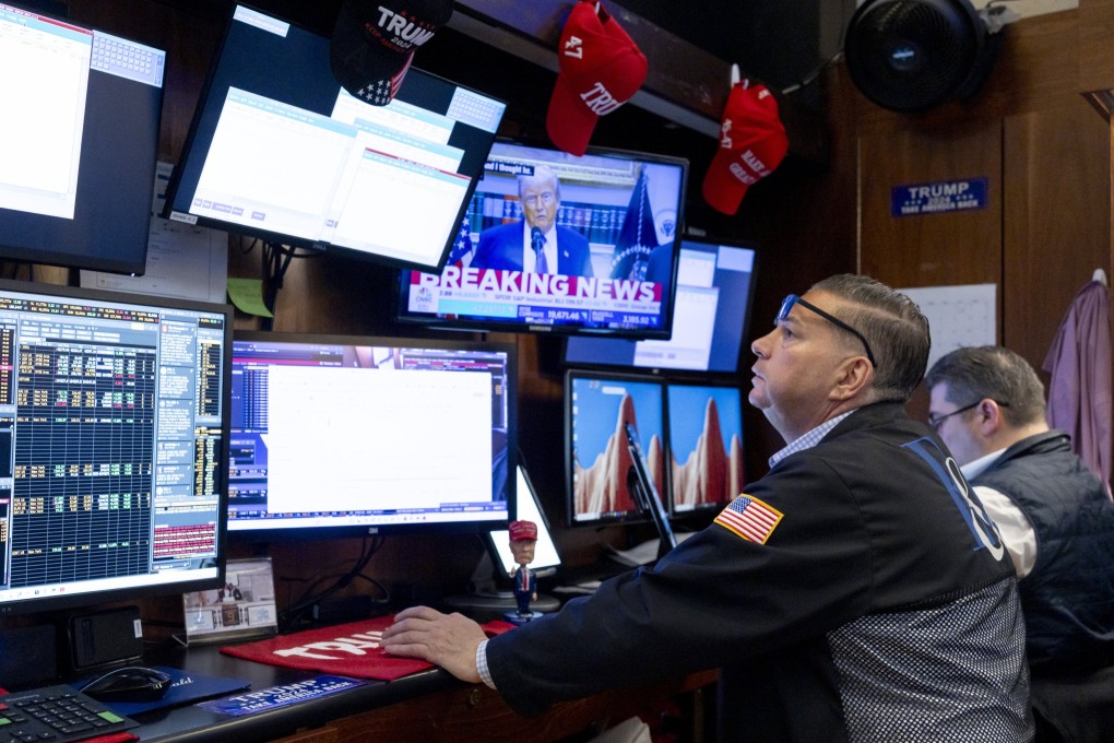 US President Donald Trump is seen on a television screen while a trader works on the floor of the New York Stock Exchange in New York on May 12. Photo: EPA-EFE