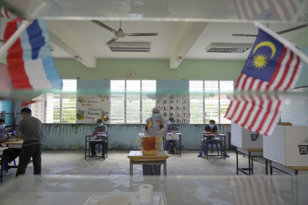A woman casts a vote at a polling station during a state election on the outskirts of Kota Kinabalu, in Malaysia’s Sabah state in September 2020. Photo: AP