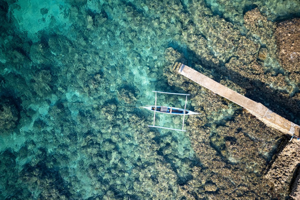 An aerial view of a fishing boat docked at a port in Bauan, Batangas province, Philippines, on March 10. Efforts to strengthen the coastguard could help lift coastal families out of poverty and enable small fishing towns to grow into vibrant regional trade centres. Photo: Reuters
