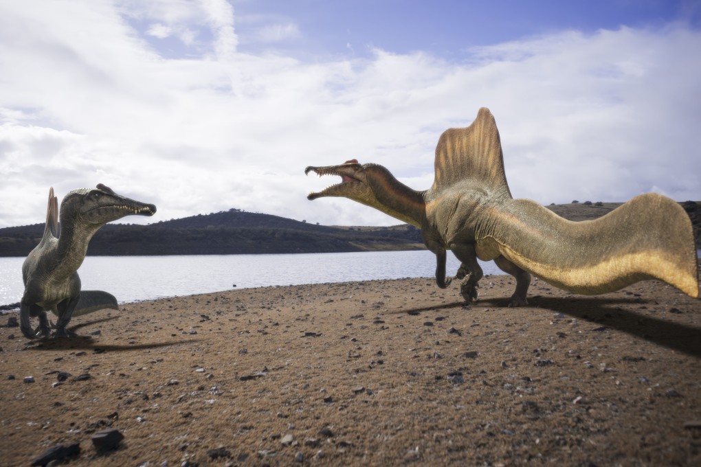 Two adult Spinosaurus  on a riverbank, in a still from BBC series Walking With Dinosaurs: Legends Unearthed. Photo: BBC/Lola Post Production